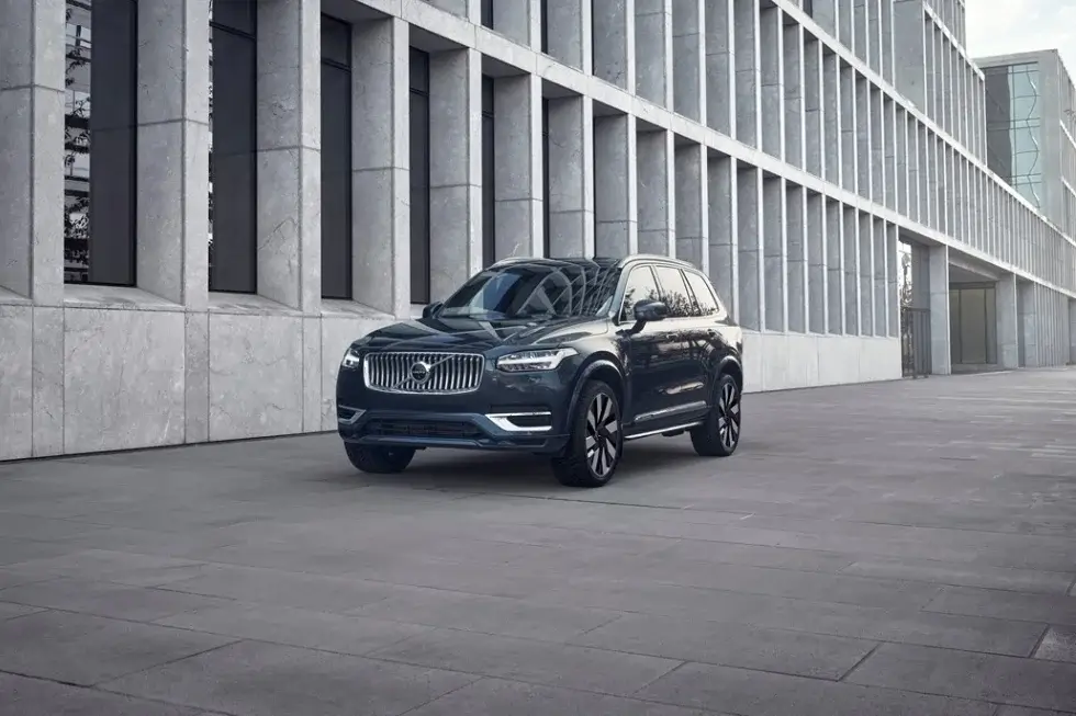 Volvo XC90 SUV parked in front of a building While not standard the Volvo XC90 can be equipped with a second-row bench seat making it a suitable option for families needing extra seating