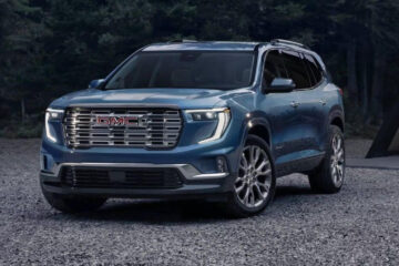 Front view of the 2025 GMC Acadia SUV in a dark metallic finish