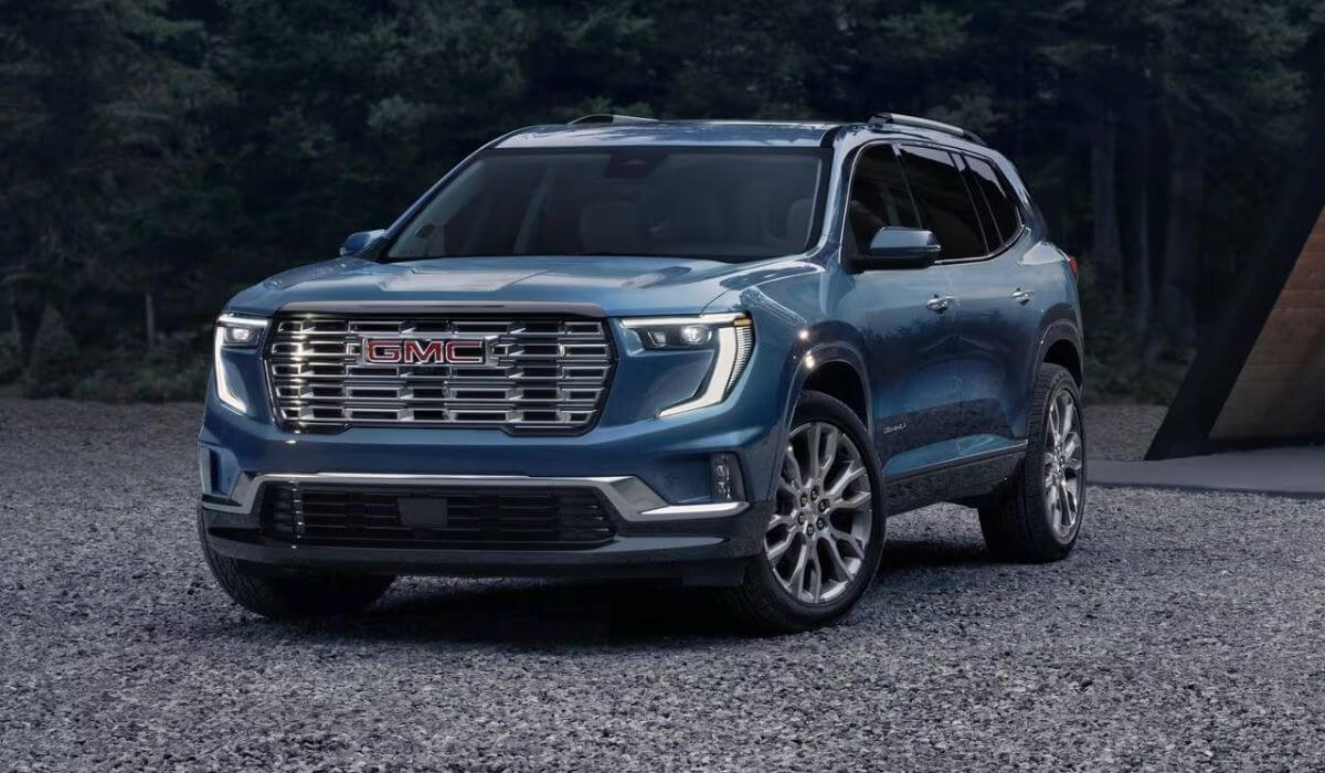 Front view of the 2025 GMC Acadia SUV in a dark metallic finish