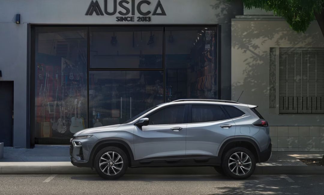 Side profile of the 2026 Chevy Tracker parked outside a music store in Brazil