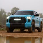 Front view of the 2026 Toyota Tundra TRD Pro in bold Wave Maker blue paint, shown in an off-road setting