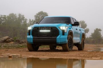 Front view of the 2026 Toyota Tundra TRD Pro in bold Wave Maker blue paint, shown in an off-road setting