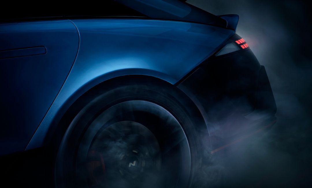 Close-up rear teaser of the 2026 Hyundai Ioniq 6 N showing its spoiler taillights and smoke-filled tire spin