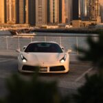 a white sports car parked in a parking lot