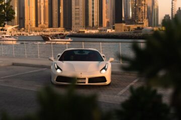a white sports car parked in a parking lot