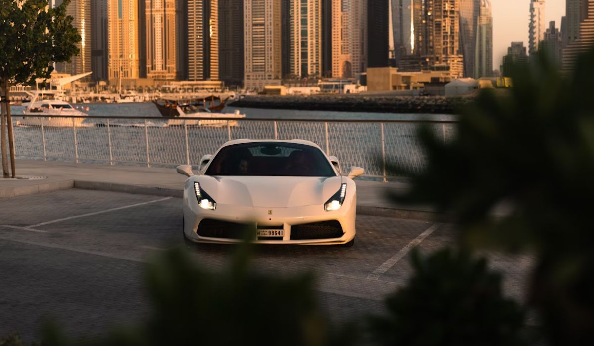 a white sports car parked in a parking lot
