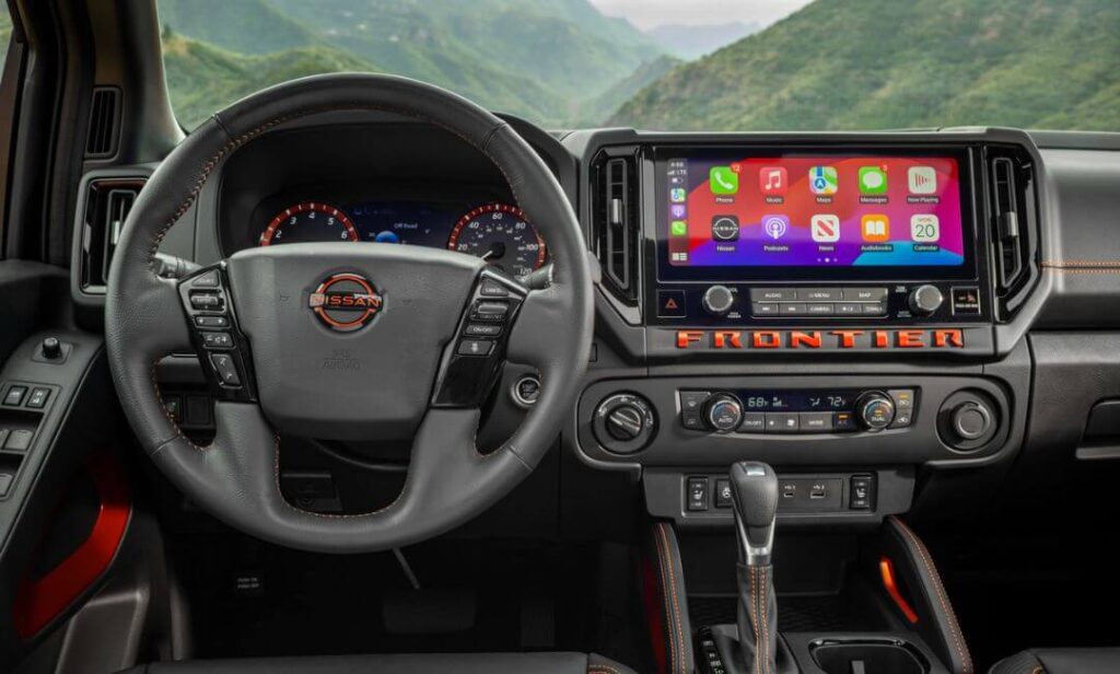 2026 Nissan Frontier PRO-4X showcasing advanced drive mode selector, heated seats, remote start, dual-zone climate control, LED lighting, and Intelligent Around View Monitor for a balance of comfort and capability.