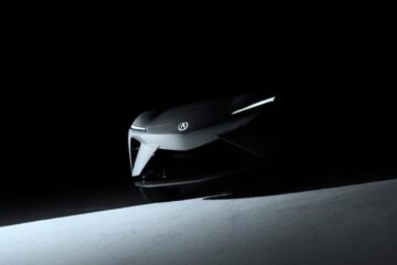 Shadowy teaser image of the Acura RSX Prototype EV front view, showing sharp headlights and Acura emblem.