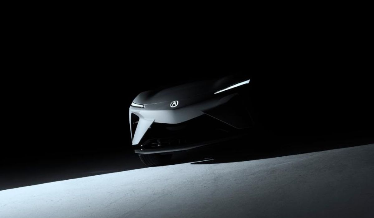 Shadowy teaser image of the Acura RSX Prototype EV front view, showing sharp headlights and Acura emblem.